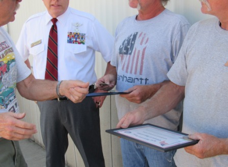 Dave Schwab presenting Challenge Coins to the Smith brothers
