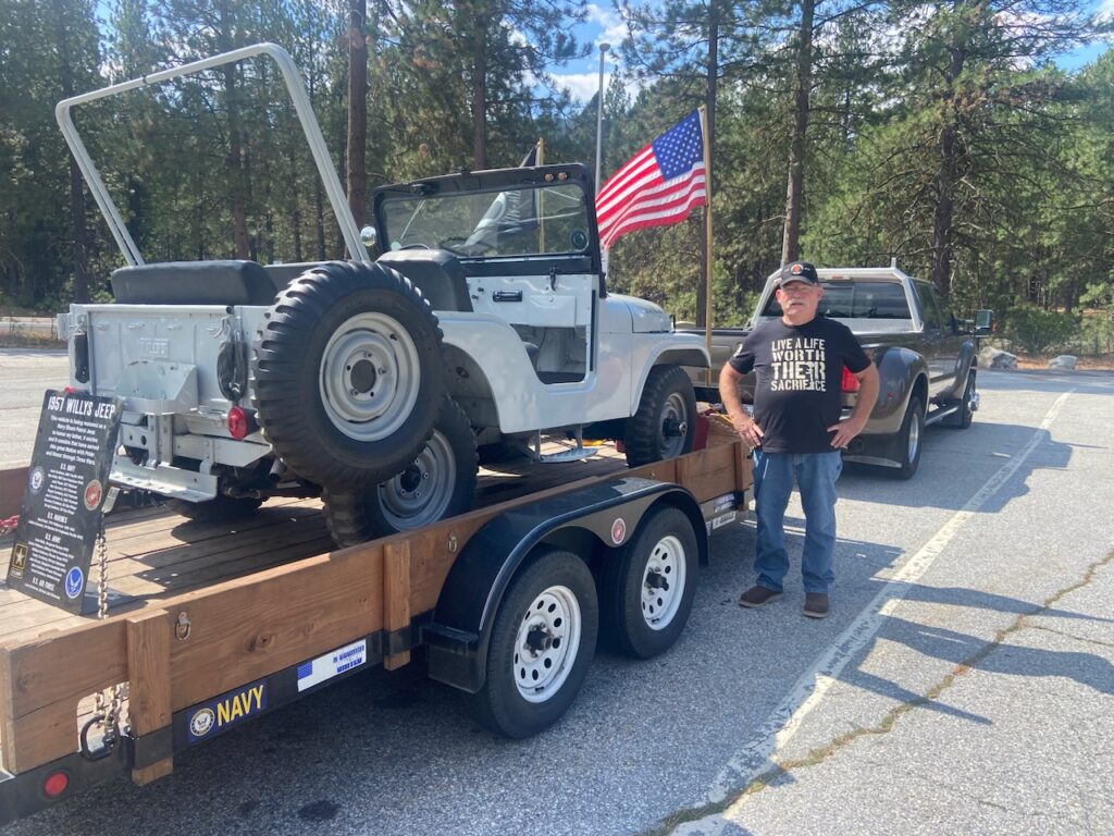 Jeep on trailer with flags at Nason Creek rest area